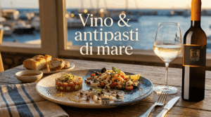 Antipasti di mare gourmet con tartare, carpaccio e insalata di mare abbinati a un calice di vino bianco Novera Falanghina al tramonto